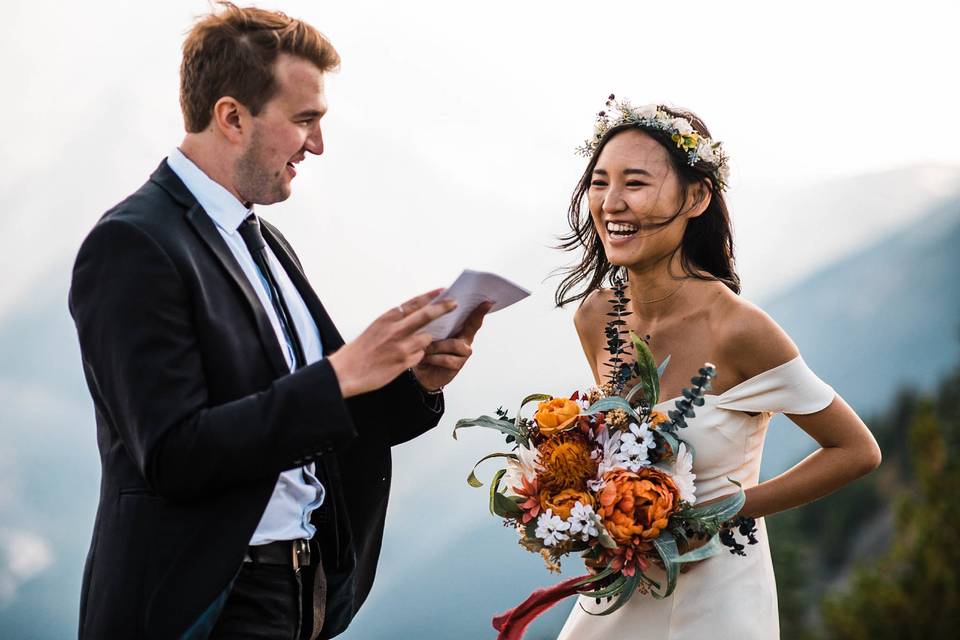 Reading letters from their family during their intimate elopement in Mt. Rainier National Park.