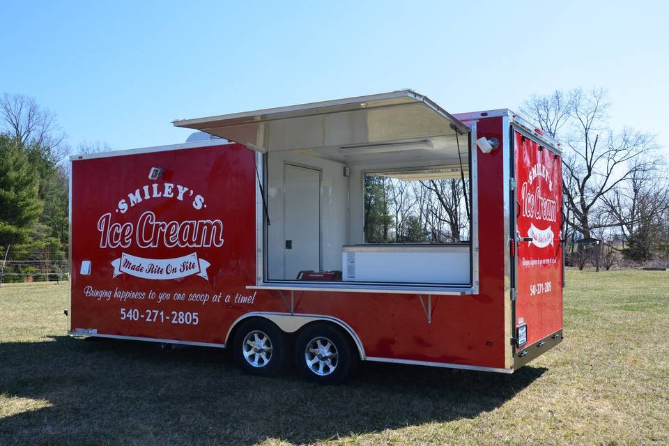 Ice cream trailer with sides opened for serving.