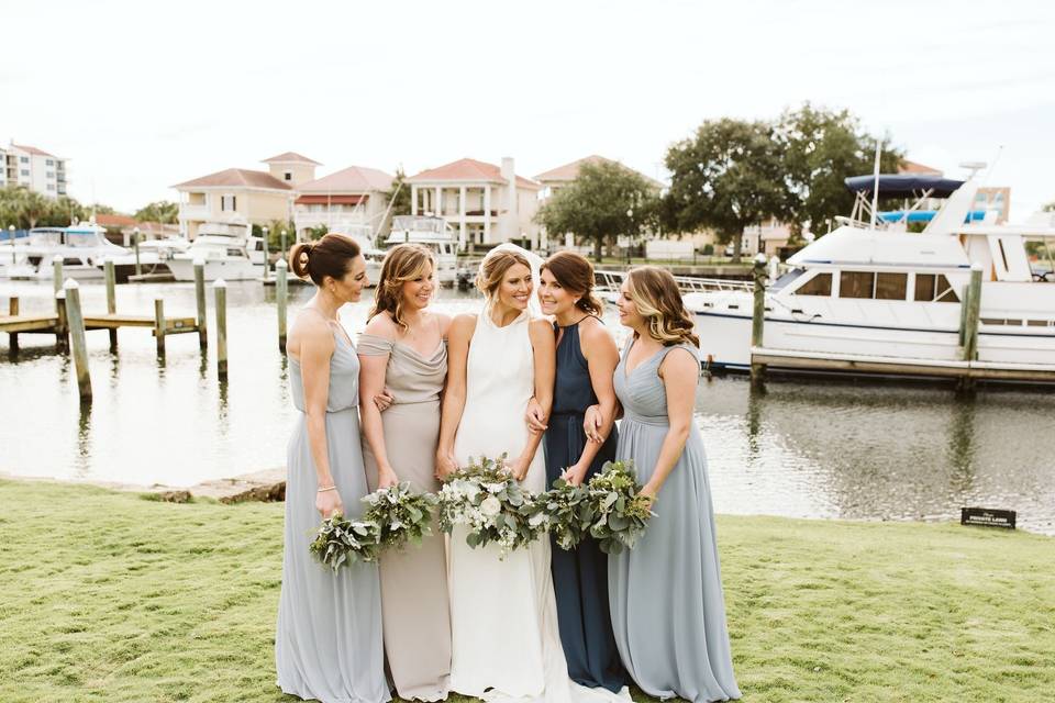 Bride and her bridesmaids by the docks