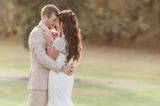 Groom is wearing a tan suit