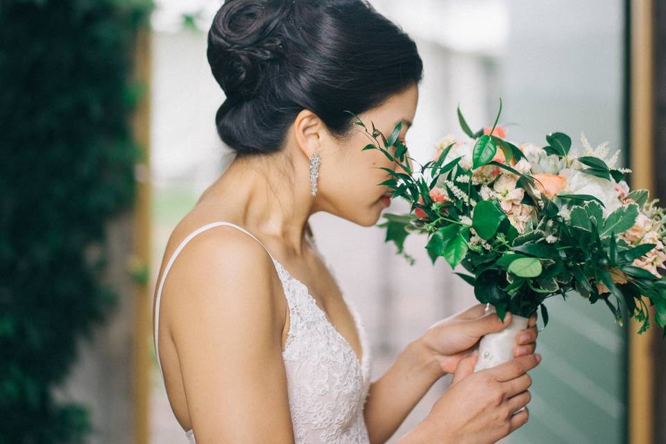 Bride smelling her flowers