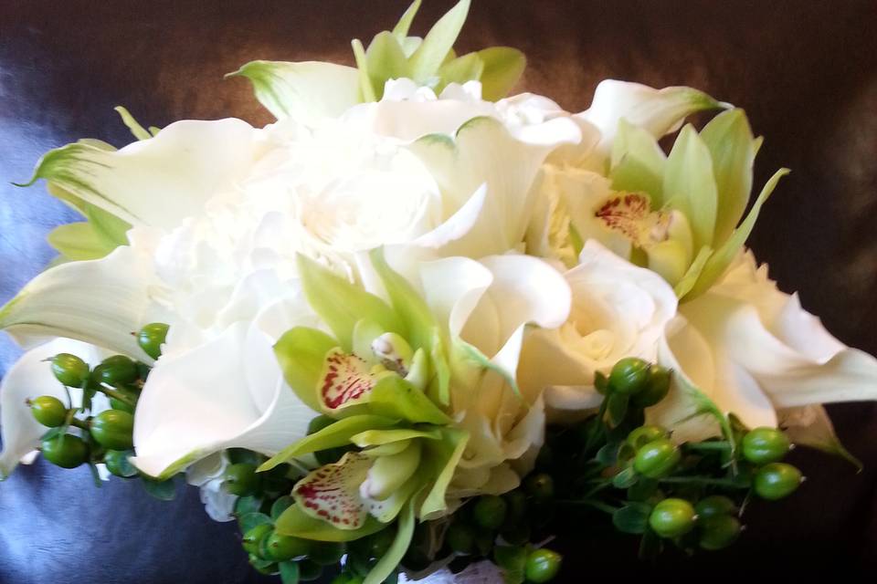 Bride and bridesmaids holding out their bouquets