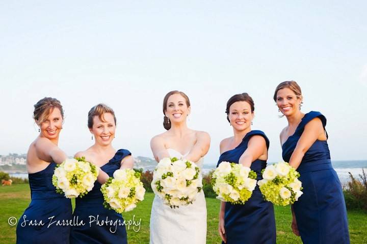 Bride and bridesmaids holding out their bouquets