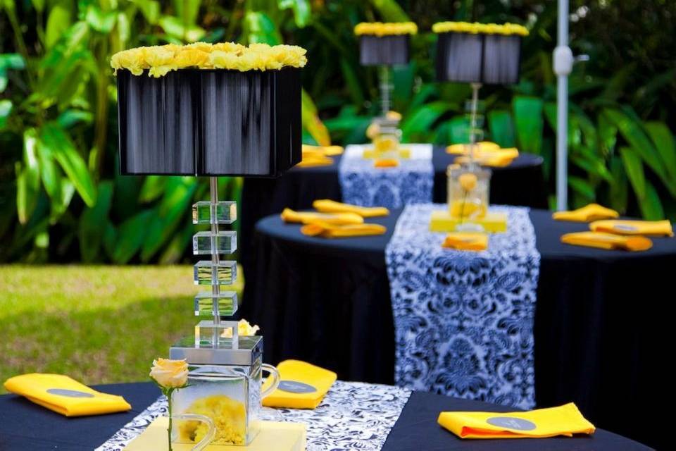 Modern wedding reception...black lamps trimmed with yellow carnations and touches of black & white damask