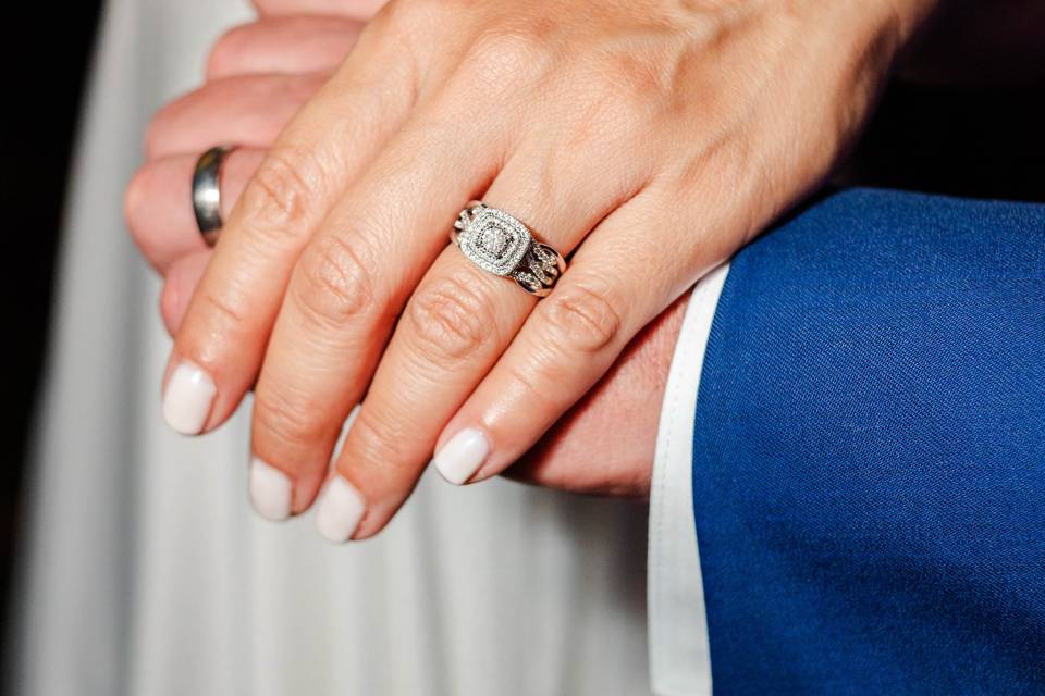 A couples hands and rings