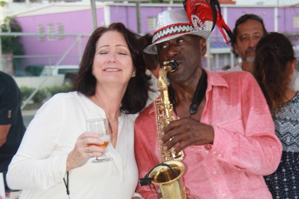 Event Guest having fun with Saxophone Serenade while sipping wine and enjoying the smooth sound of the saxophone