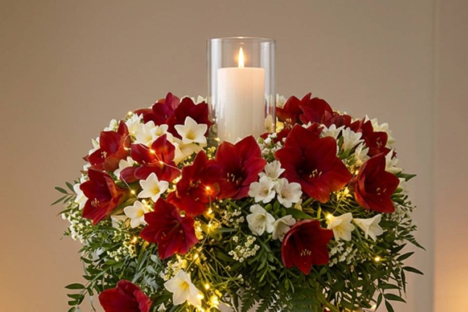 Red-white cascading centerpiece with candle and fairy lights.png