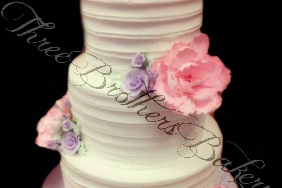 White wedding cake with pink flowers