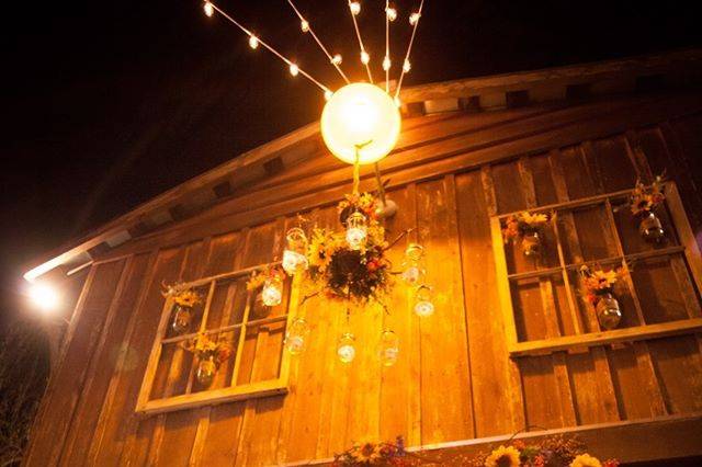 Rustic barn wedding cake with burlap ribbon accent and sunflowers