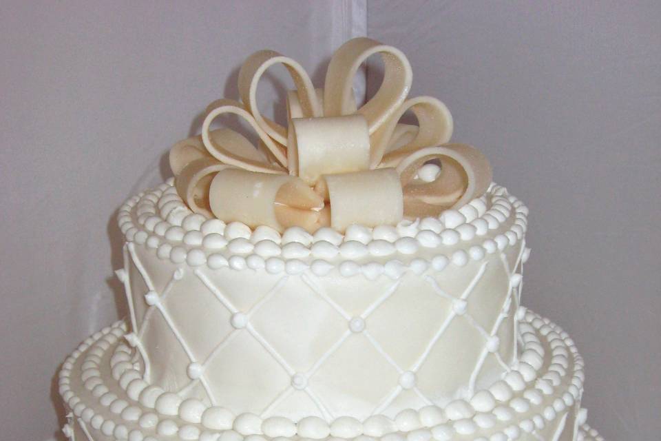 Wedding cake with gold bow on top