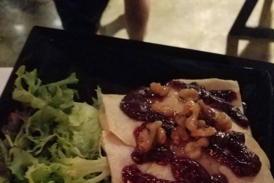 Raspberry Chicken crepe plated with salad and couscous. Our best seller! Cheddar, grilled chicken breast, tomato and spinach inside, topped with raspberry preserves and walnuts. Savory and sweet!