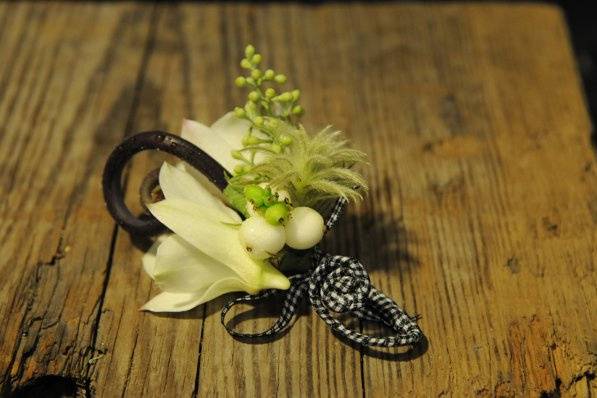 Checkered ribbon makes this ring bearer's dendrobium orchid boutonniere 