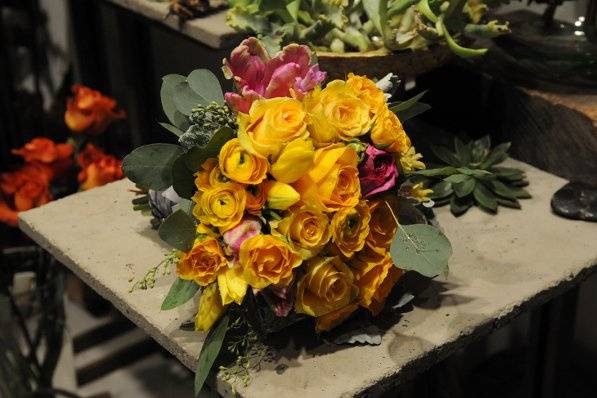 Cheerful are the warm golden roses in this spring bridal bouquet.