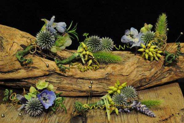 Delphinium, thistle, eucalyptus pods and herbs are used in these playful boutonnieres.