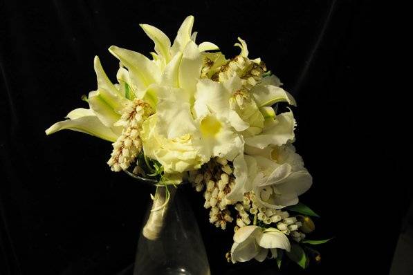 This gently cascading bridal bouquet is made with fragrant lilies and phalaenopsis.