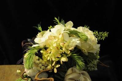 Vintage and eclectic, this bridal bouquet is embellished with family heirloom fabric and jewelry.