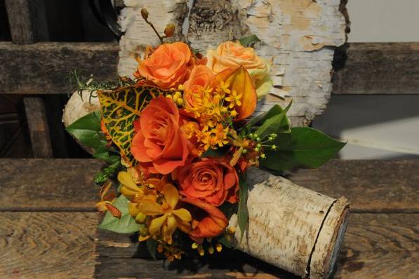 Roses, vanda orchids and warm tones and textures make this bouquet complete.