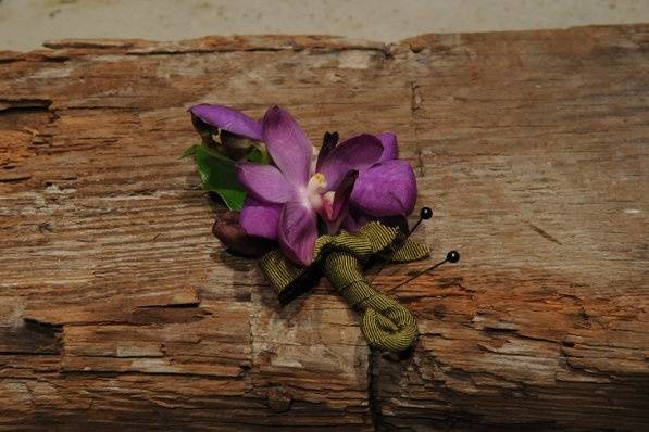 A vanda orchid boutonniere in deep purple.