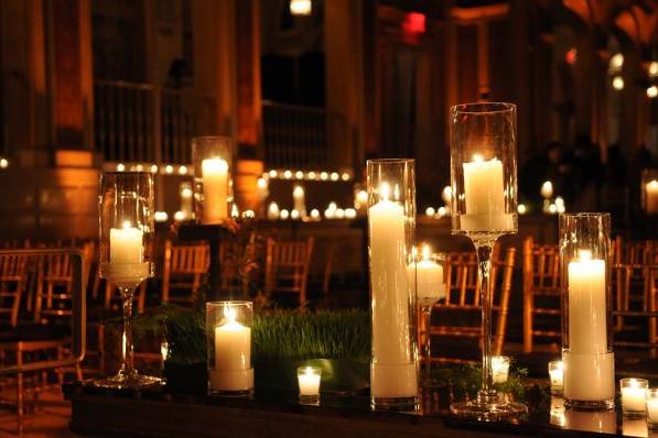 Numerous pillar candles create an elegant, romantic atmosphere for the ceremony.