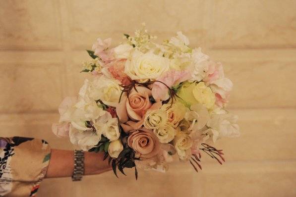 Lush and romantic, this fragrant bridal bouquet includes garden roses and lily of the valley.