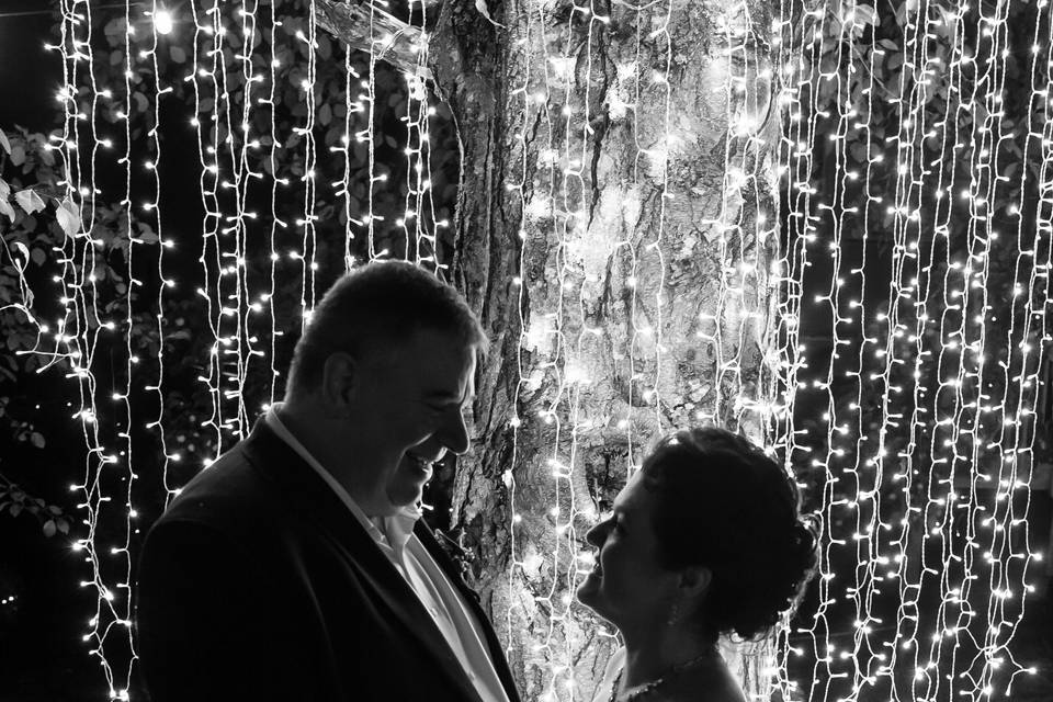 Couple silhouetted in lights.