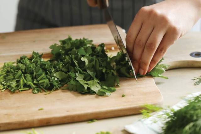 Chef chopping herbs