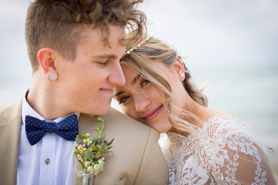 Brides head on grooms shoulder