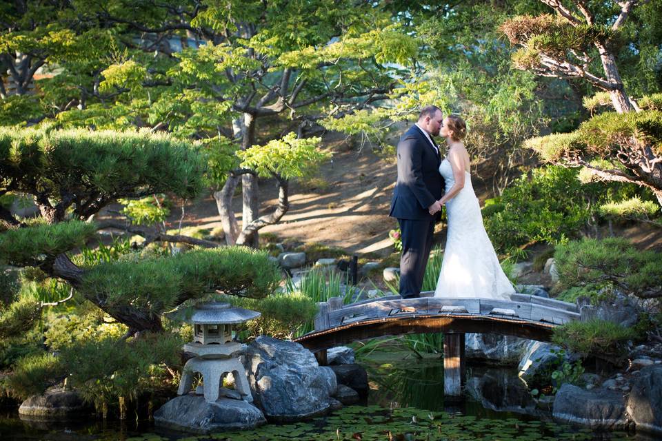 Couple kissing on a bridge