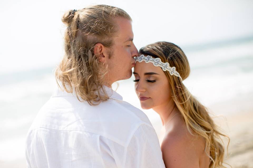 Groom kissing brides head