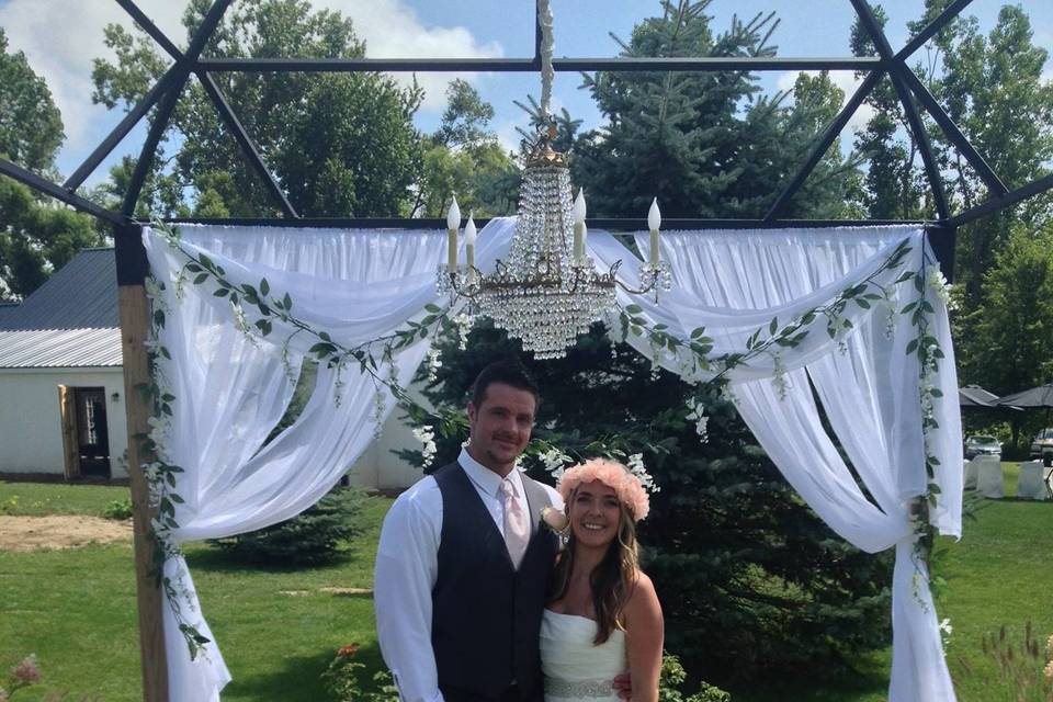 Couple underneath a wedding arch