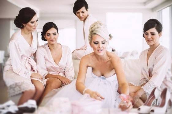 Bridesmaids are wearing the popular blush pink with lace detail Bella Robe from Homebodii.