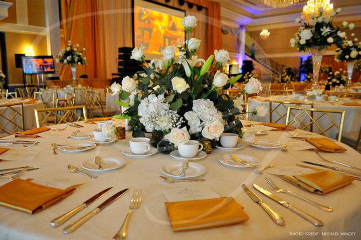 White table setup with gold plates
