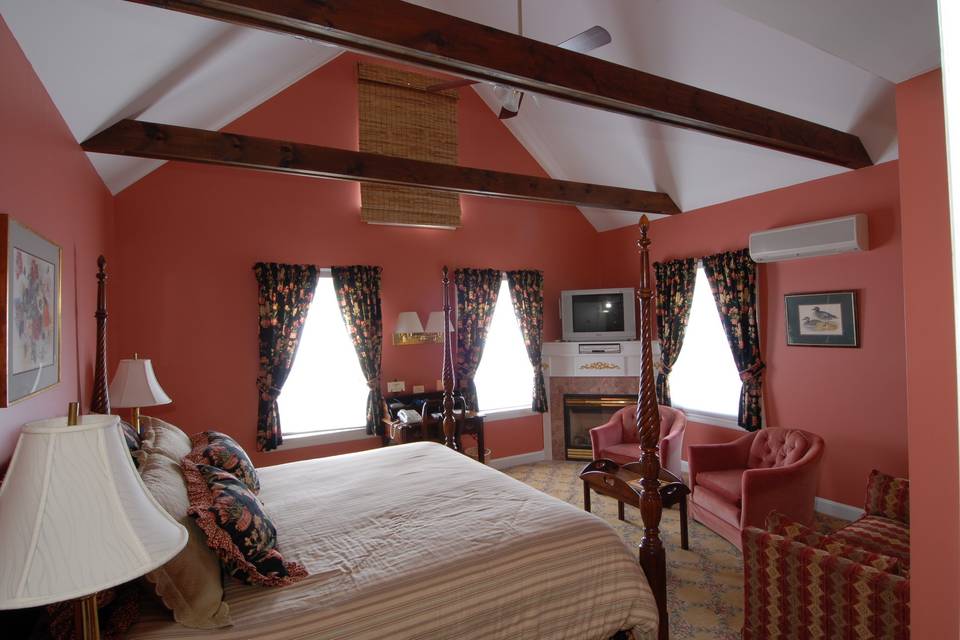 Room 209, beautifully decorated king room with fireplace and vaulted ceiling.