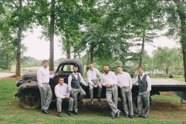 Groom and his groomsmen by the truck