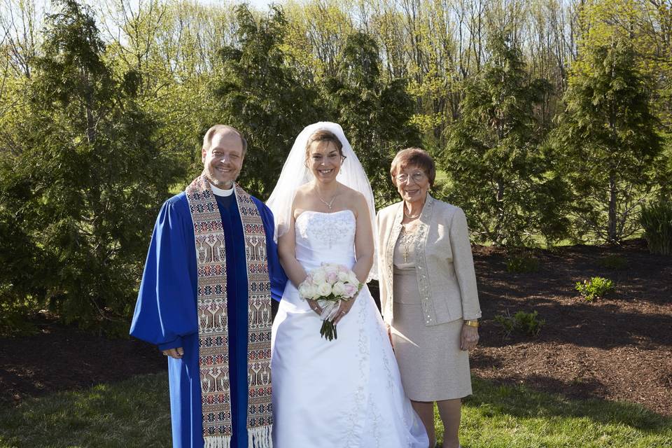 Officiant with the bride and mother