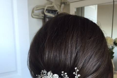 Neat wedding updo with accessory