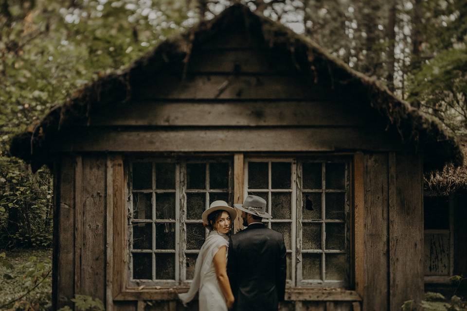 Couple posing beside cabin