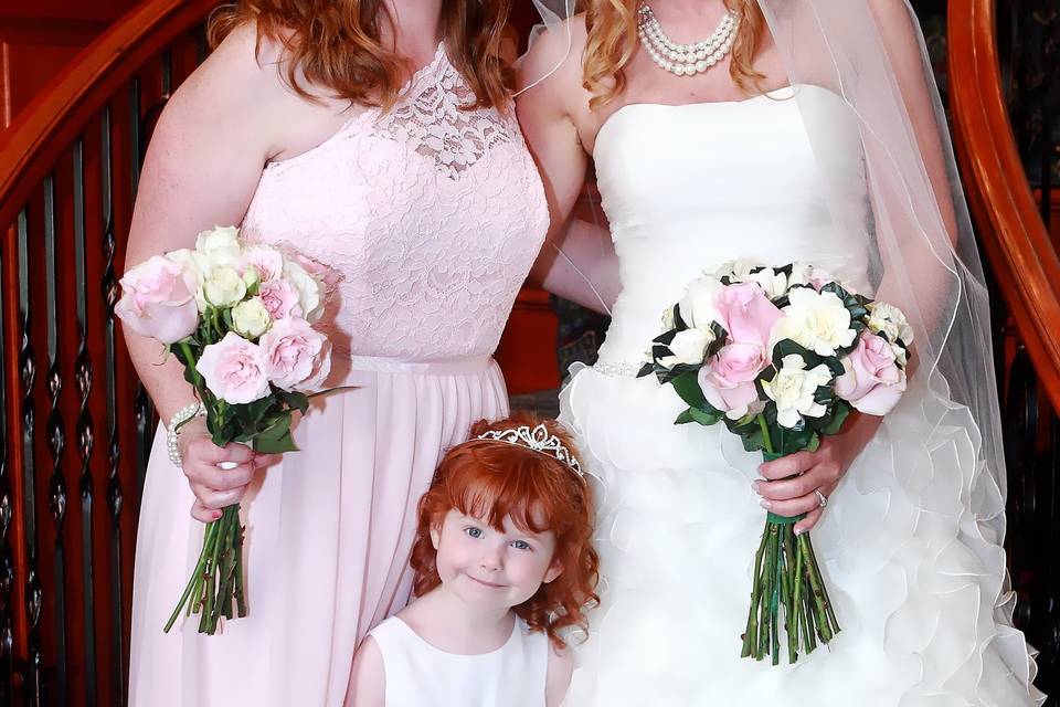 Bride and bridesmaid with flower girl