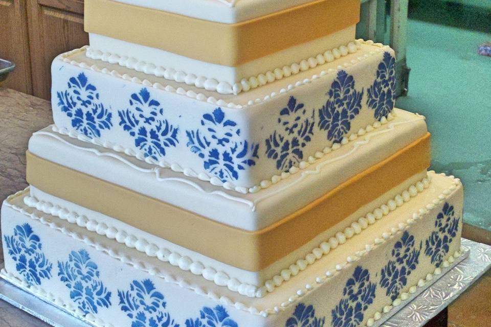 4-tier wedding cake with blue detailing