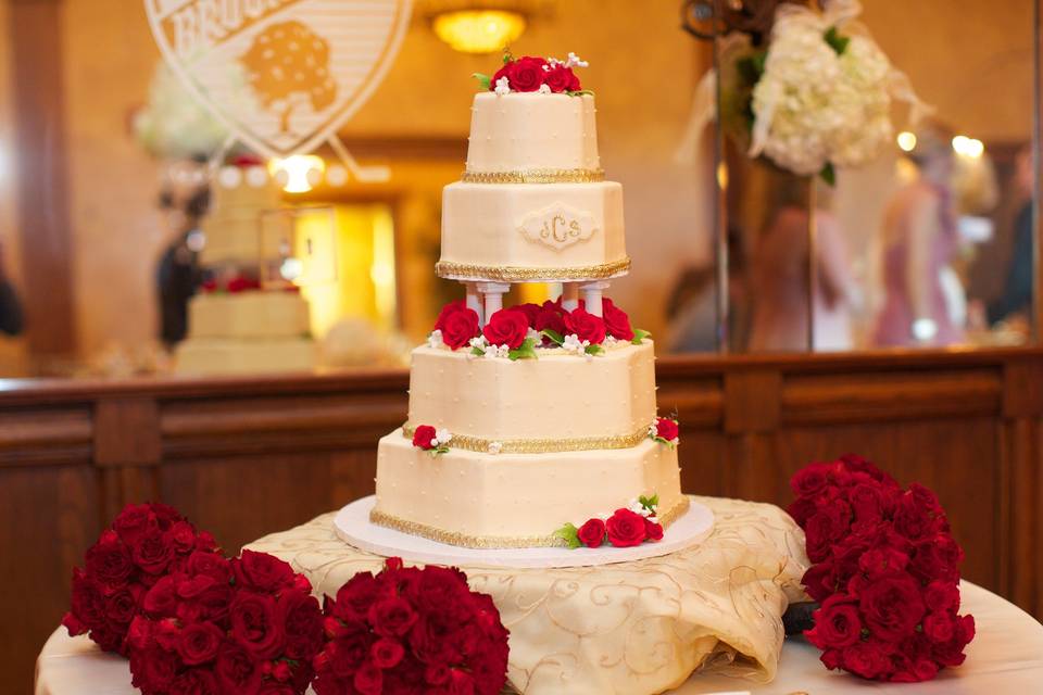 Red flower bouquets and wedding cake