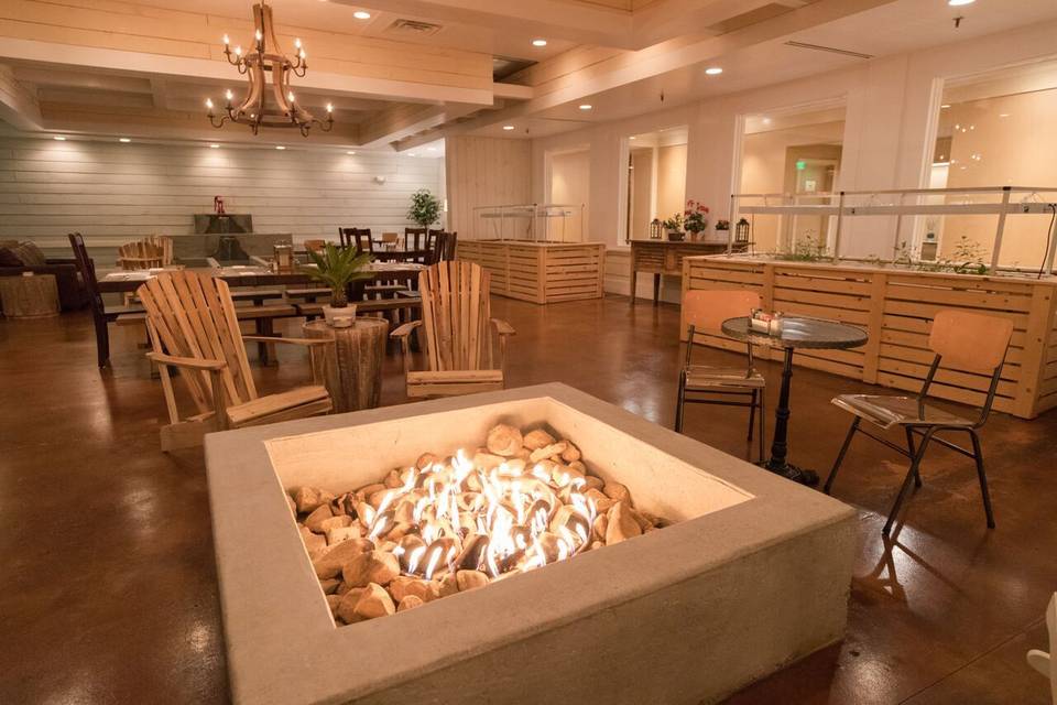 Our indoor “outdoor style” Barn Room patio room complete with large cascading fountain, fire pit area, Adirondack chairs & rustic furnishings, rough sawn barn wood paneling and hydroponic growing stations. Who needs a Barn for a rehearsal dinner!