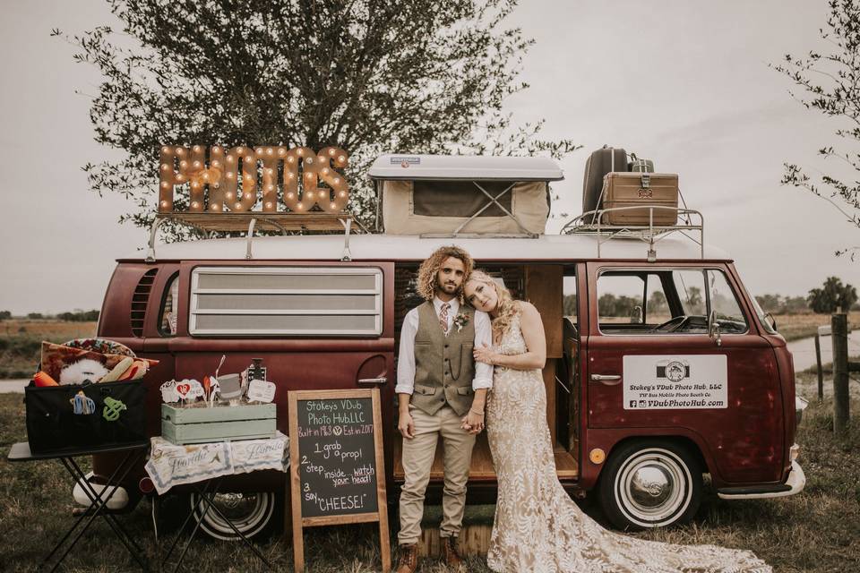 Newlyweds by the Volkswagen bus photo booth