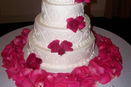 Pink roses and petals accent this soft romantic cake. White and strawberry cake with strawberry fillings were the brides choice of flavors.