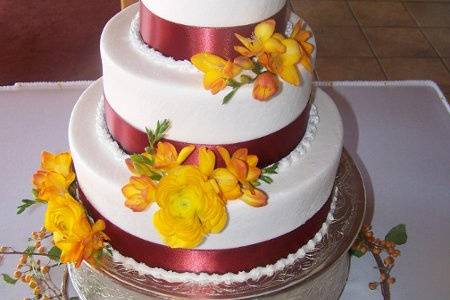 This beautiful cake was an applesauce spice cake with buttercream frosting. Accented with bright fall colors, this is a cake fitting for any fall wedding.