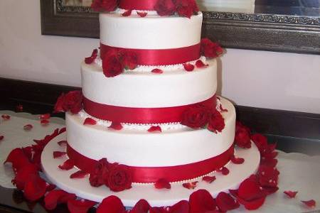 Pink roses and petals accent this soft romantic cake. White and strawberry cake with strawberry fillings were the brides choice of flavors.