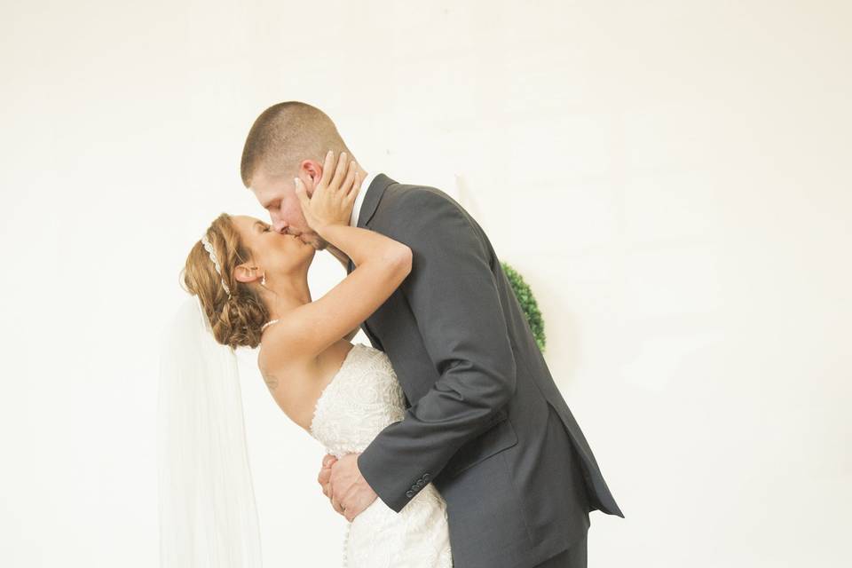 Groom kissing his bride