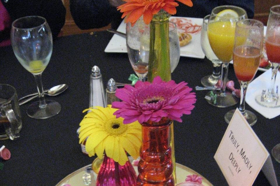 Reception centerpiece with yellow, pink, orange gerbera daisy