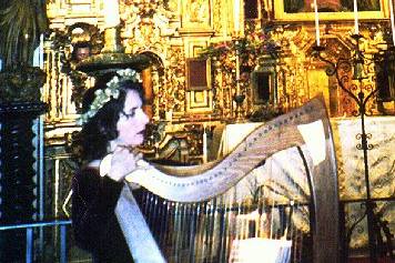 Harpist Stephanie Bennett plays Celtic harp for a Medieval-themed wedding ceremony, in the chapel of the Mission Inn, Riverside, California