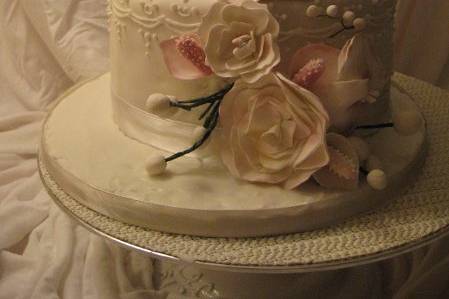 tiered wedding cake with fondant icing and piping