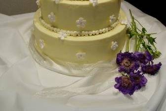 tiered wedding cake with buttercream icing and sugar flowers